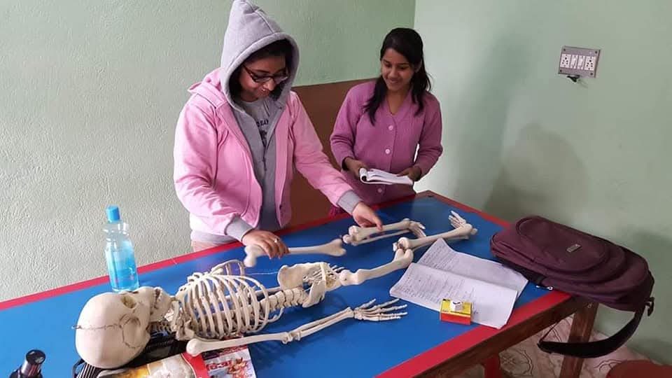 BIORTON students studying a human skeleton model in the biology lab