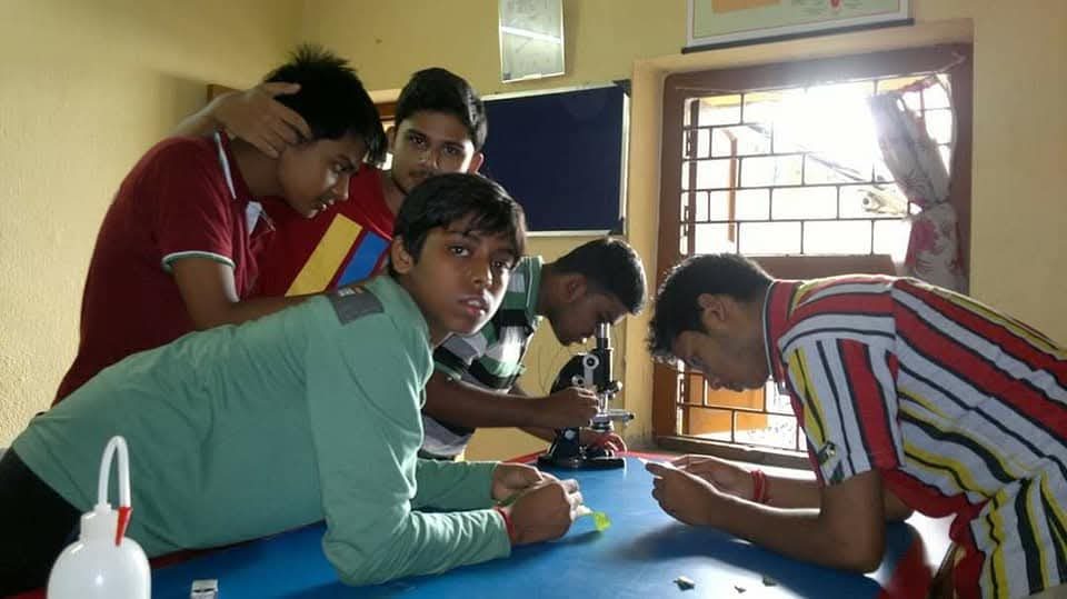 BIORTON students taking turns at the microscope